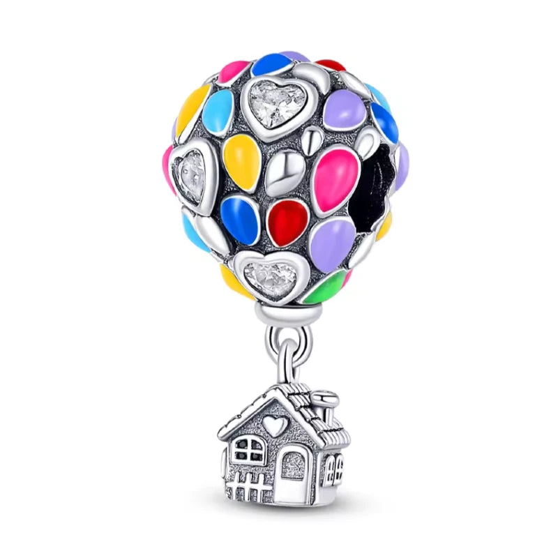 Colorful heart-shaped charm with a house pendant on a white background