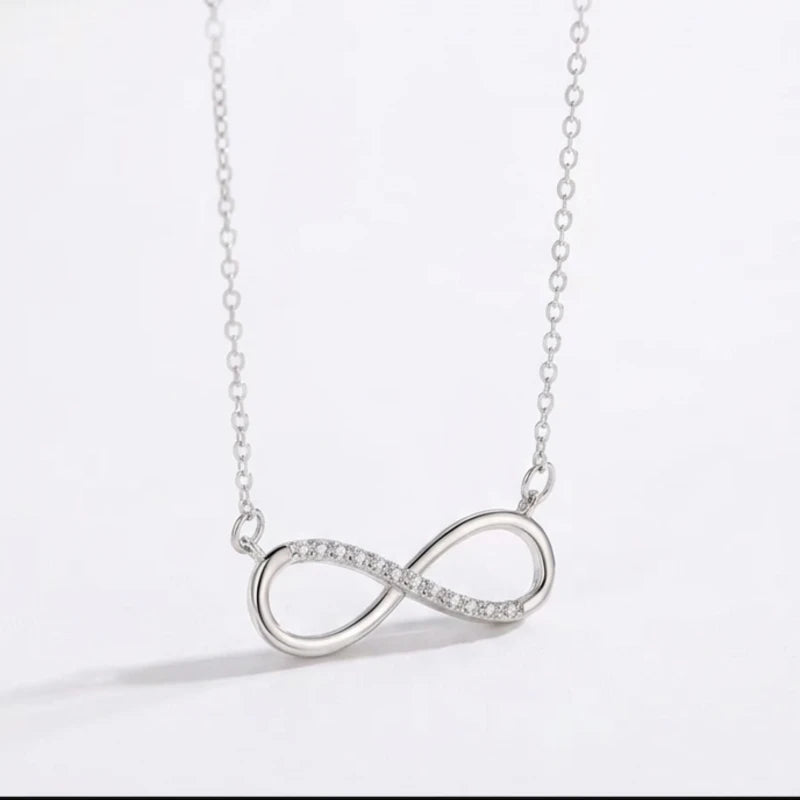 Silver infinity necklace on a WHITE BACKGROUND