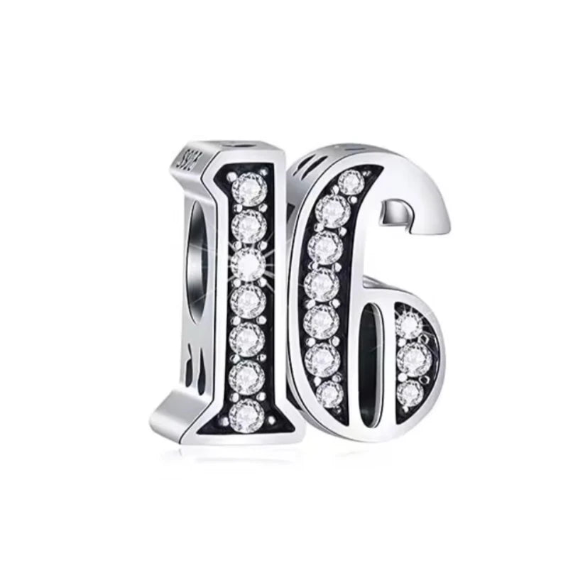 Silver earrings with '16' design and clear gemstones on a white background