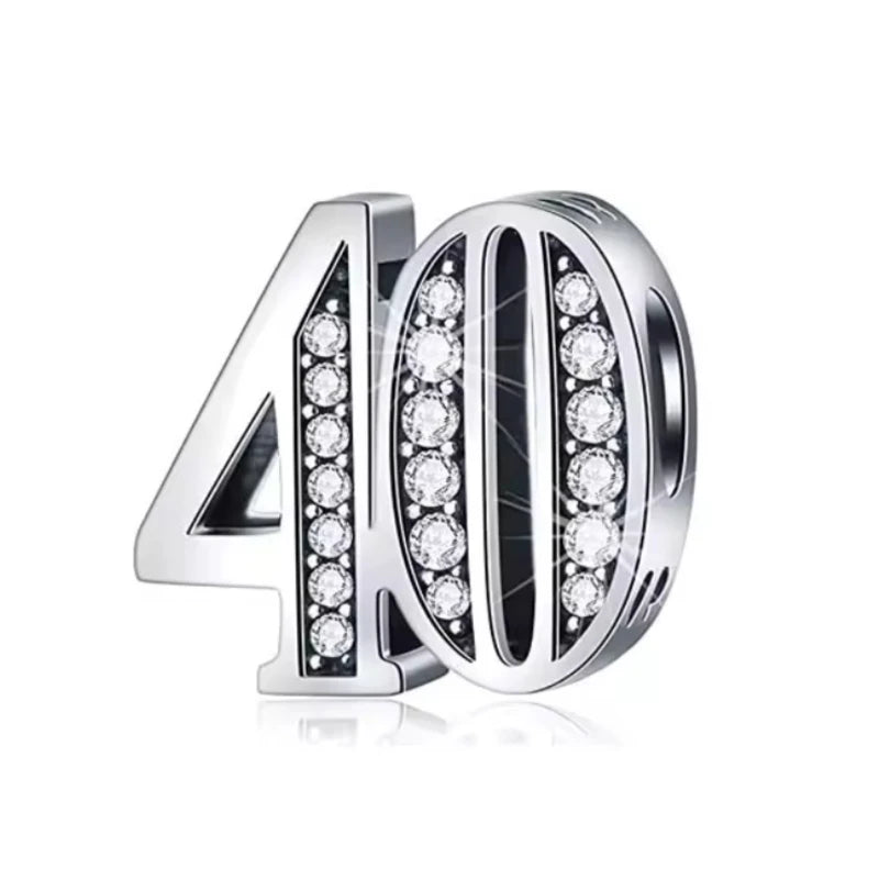 Silver charm with '40' and clear gemstones on a white background