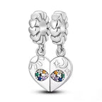 Silver heart-shaped earrings with gemstones on a white surface 