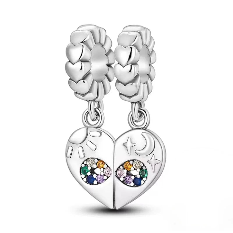 Silver heart-shaped earrings with gemstones on a white surface 